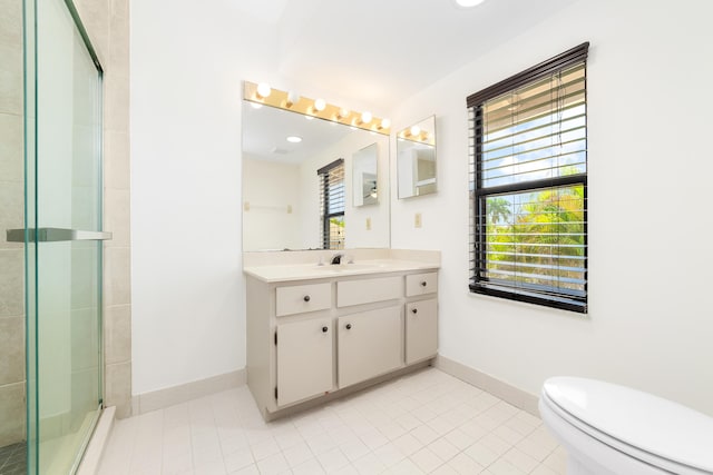 bathroom featuring a healthy amount of sunlight, toilet, an enclosed shower, and vanity