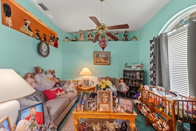 living room featuring ceiling fan and a healthy amount of sunlight