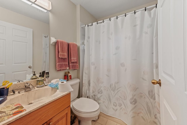 bathroom featuring toilet, vanity, and tile patterned floors