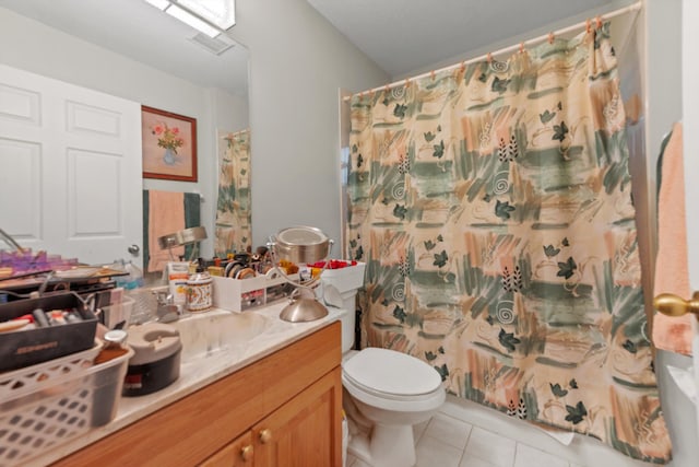 bathroom featuring toilet, a shower with curtain, vanity, and tile patterned floors