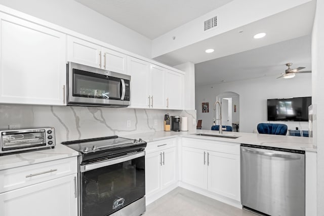 kitchen featuring white cabinets, stainless steel appliances, and sink