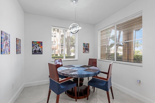 tiled dining space featuring a chandelier