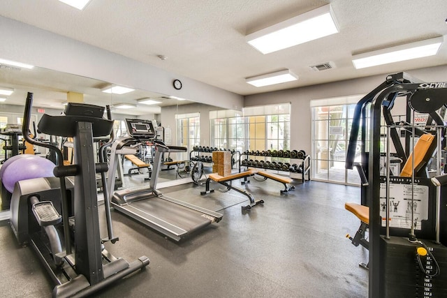 workout area featuring a textured ceiling