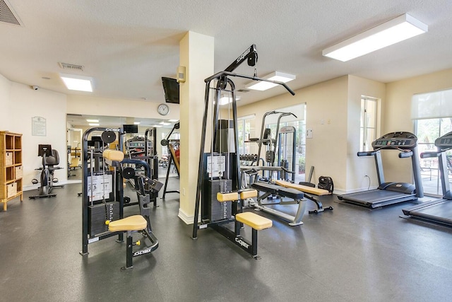 workout area with a textured ceiling