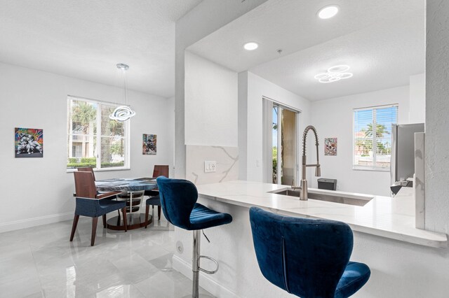 kitchen with white cabinetry, stainless steel appliances, sink, and decorative backsplash