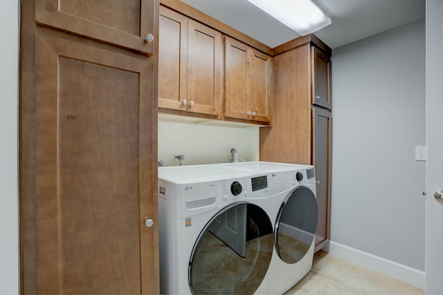 laundry room featuring independent washer and dryer and cabinets