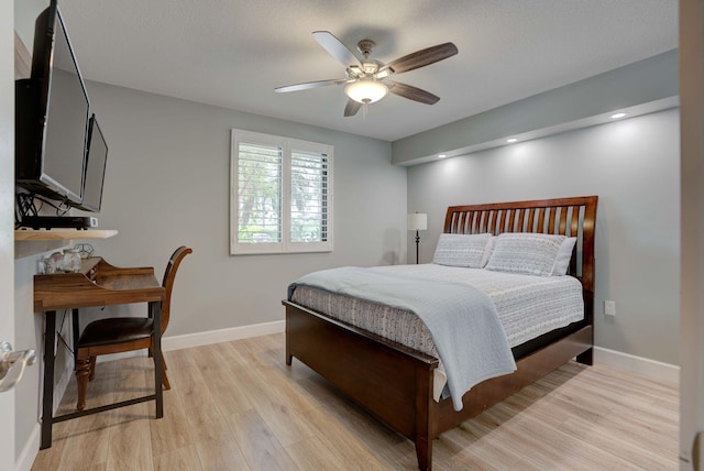 bedroom with ceiling fan and light hardwood / wood-style flooring