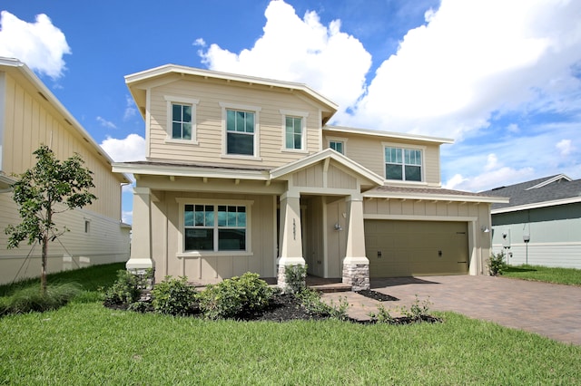 view of front of house with a garage and a front yard