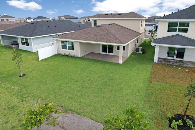 rear view of house featuring a patio area, a lawn, and central AC unit