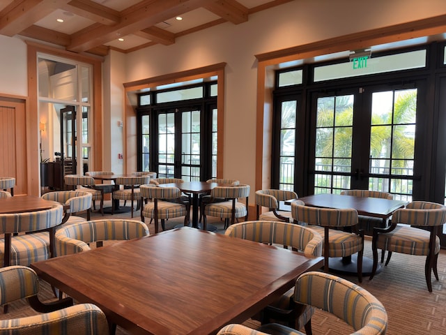 dining space featuring french doors, beamed ceiling, and coffered ceiling