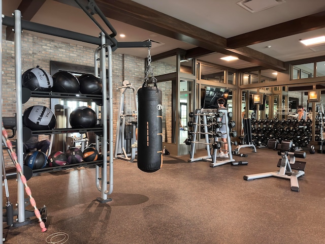 exercise room featuring brick wall