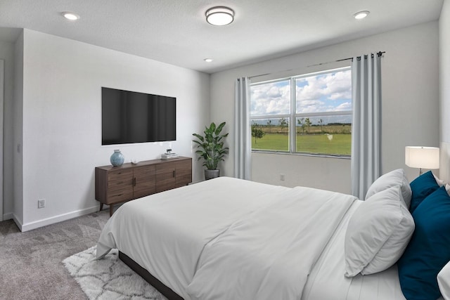 carpeted bedroom featuring a textured ceiling