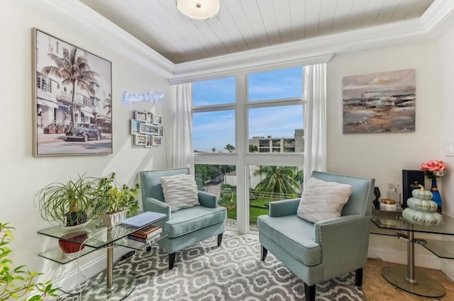 sitting room with crown molding and wood ceiling