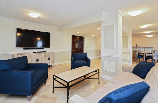 living room with tile patterned floors, crown molding, a textured ceiling, and decorative columns