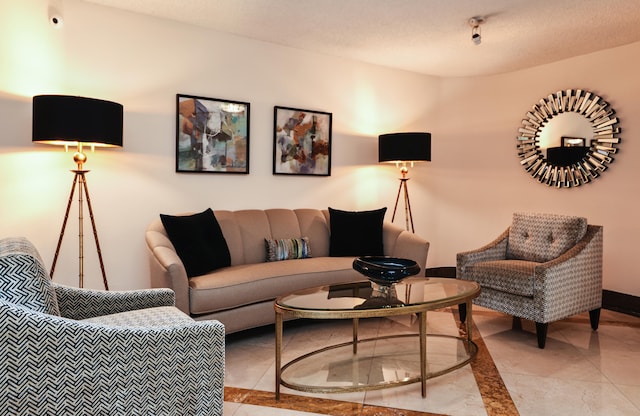 tiled living room featuring a textured ceiling