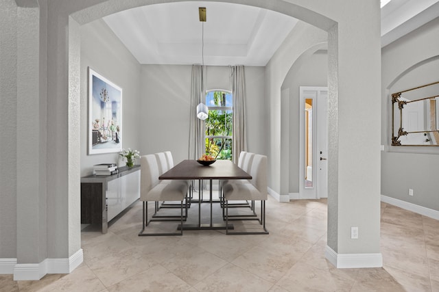 dining space featuring a tray ceiling