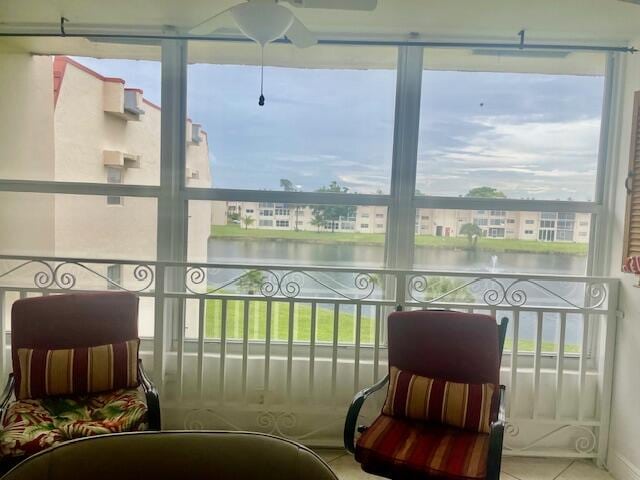 sunroom / solarium with a water view