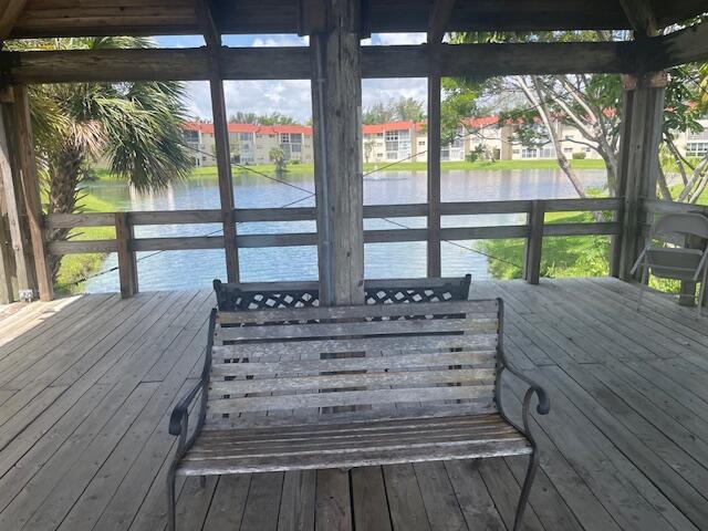 wooden deck featuring a water view