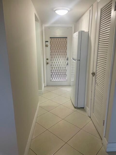 hallway featuring light tile patterned flooring