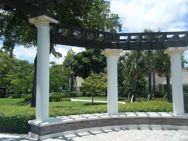 view of home's community featuring a pergola and a lawn