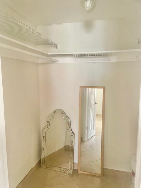 2700 Sunrise Lakes Dr W Unit 301, Sunrise, FL 33322 - spacious closet featuring visible vents and light tile patterned floors