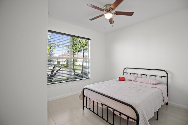 bedroom with ceiling fan and light tile patterned floors