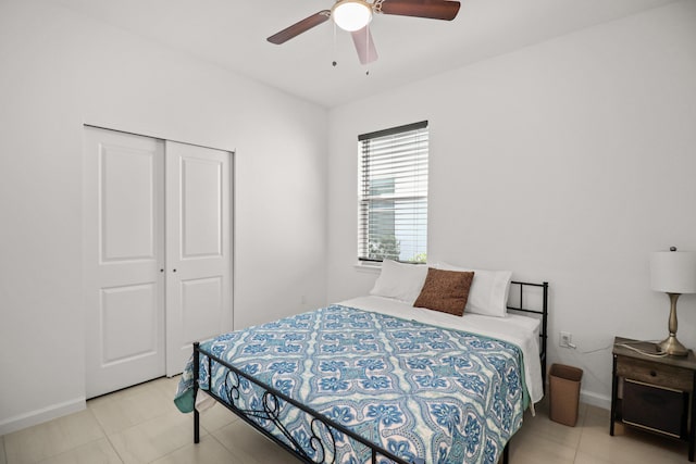 tiled bedroom featuring a closet and ceiling fan