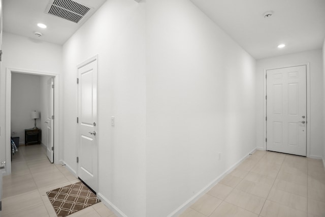 hallway featuring light tile patterned floors