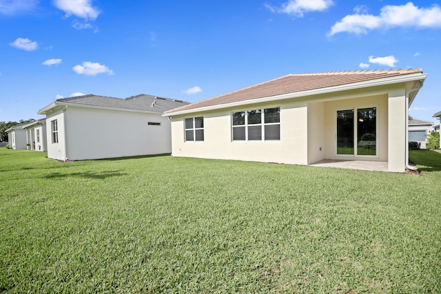 rear view of property featuring a yard