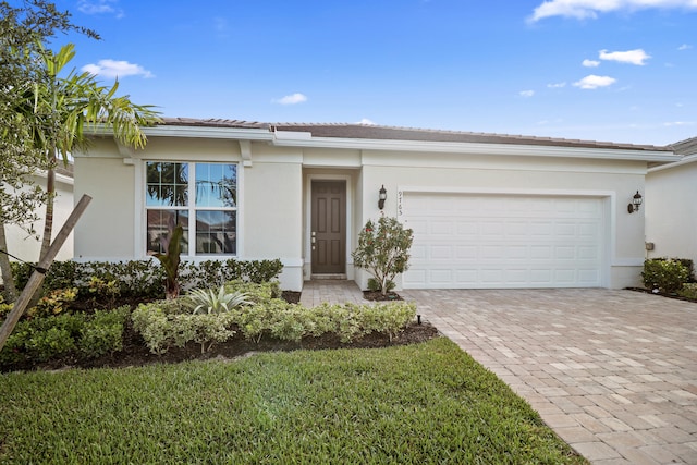 view of front of property featuring a garage and a front lawn