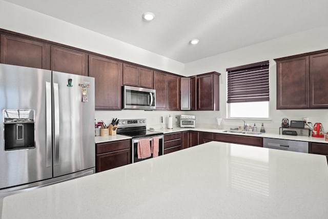 kitchen featuring dark brown cabinets, stainless steel appliances, and sink