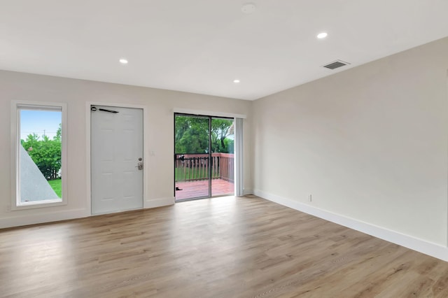 unfurnished room with light hardwood / wood-style flooring and a wealth of natural light