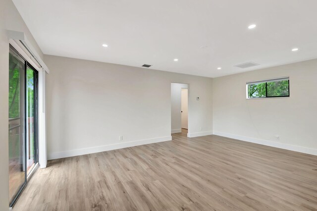 unfurnished room with plenty of natural light and light hardwood / wood-style floors