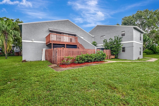 rear view of house featuring a yard