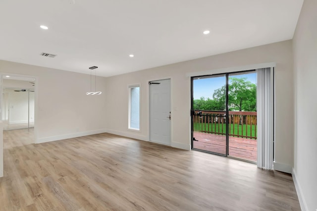 empty room with light hardwood / wood-style flooring