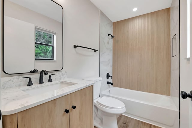 full bathroom with wood-type flooring, vanity, toilet, and bathtub / shower combination