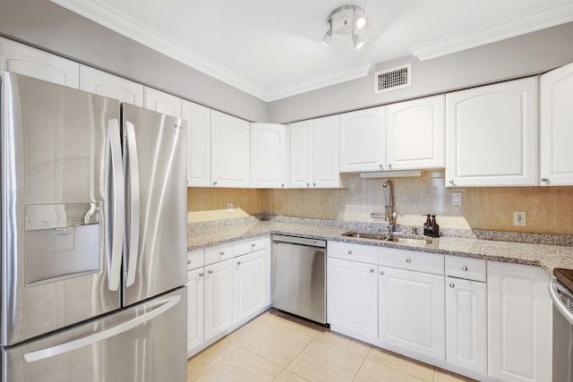 kitchen featuring white cabinets, light stone counters, sink, and appliances with stainless steel finishes