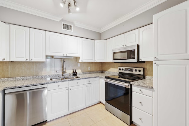 kitchen featuring sink, ornamental molding, appliances with stainless steel finishes, light stone counters, and white cabinetry