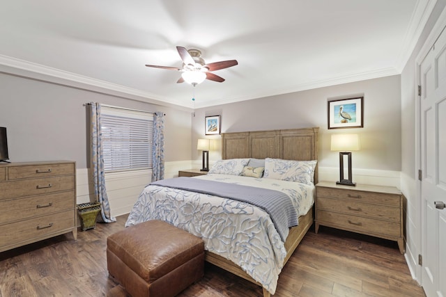 bedroom featuring ceiling fan, dark hardwood / wood-style flooring, and crown molding