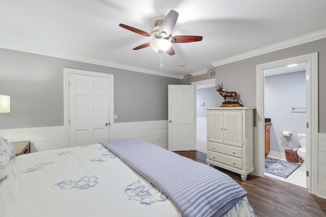 bedroom featuring dark hardwood / wood-style flooring, ensuite bathroom, ceiling fan, and crown molding