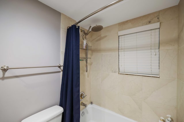 bathroom featuring shower / bathtub combination with curtain and toilet