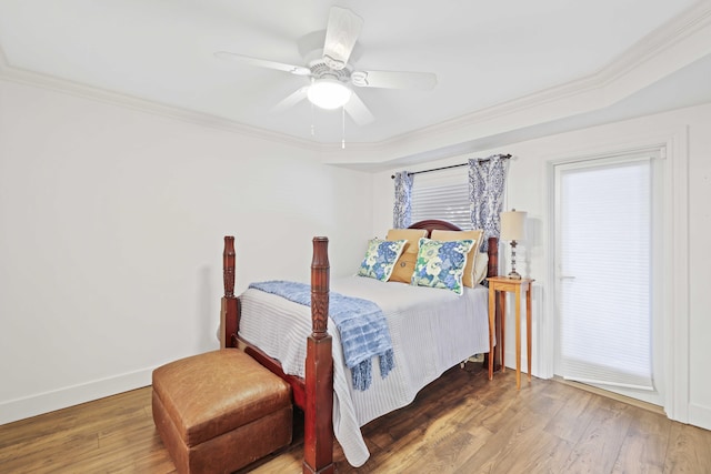 bedroom featuring hardwood / wood-style flooring, ceiling fan, and ornamental molding