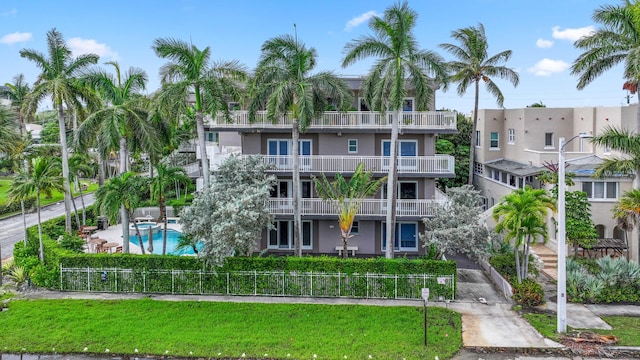 view of building exterior with a fenced in pool