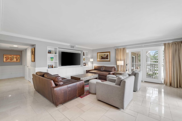 living room featuring built in shelves and crown molding