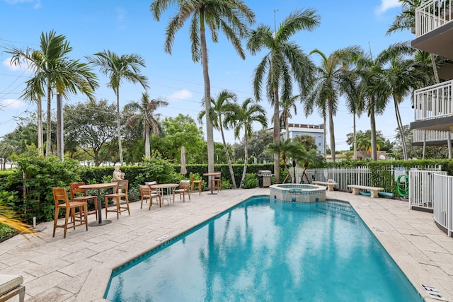 view of swimming pool with an in ground hot tub and a patio