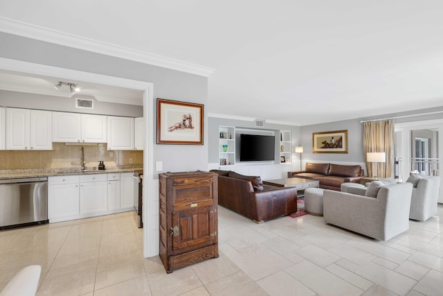 tiled living room with built in shelves, crown molding, and sink