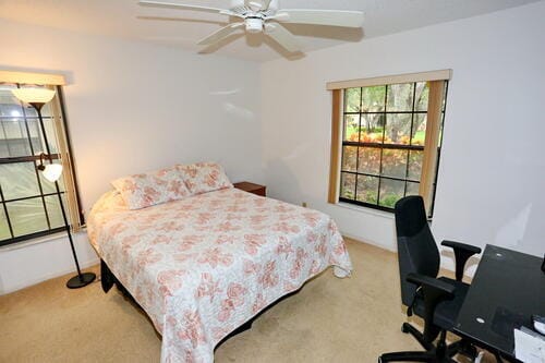 carpeted bedroom with ceiling fan