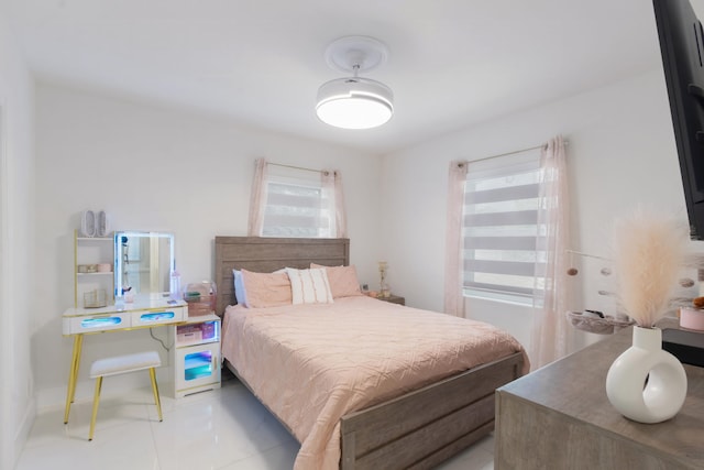 bedroom featuring light tile patterned floors and multiple windows