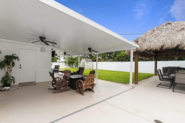 view of patio / terrace featuring a storage shed, area for grilling, and ceiling fan