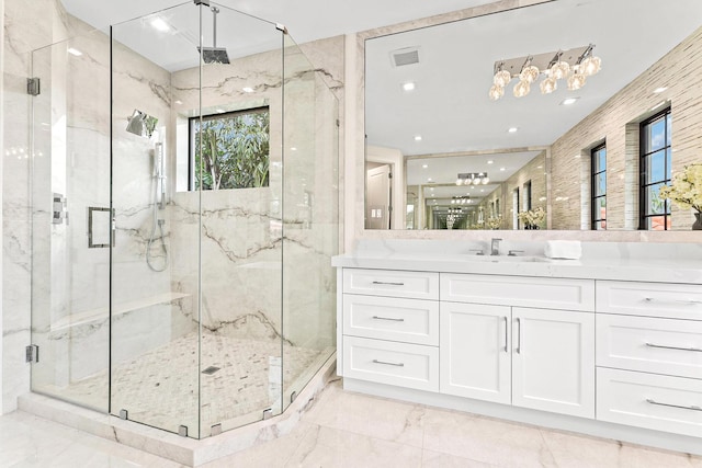 bathroom with walk in shower and vanity